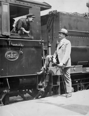 Joseph Gordon Coates speaking with the driver of locomotive Ab825 at Auckland Railway Station