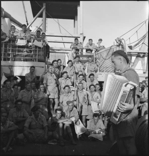 R J Hughes plays for the community sing on board transport to Italy, World War II