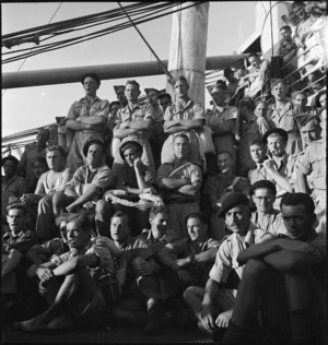 Men of 2 NZ Division hold community sing on board transport to Italy, World War II