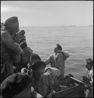 Members of 2 NZ Division bartering with bumboat vendors on arrival in an Italian harbour, World War II - Photograph taken by M D Elias