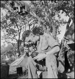 N Nicholson adjusts the caburettor of his vehicle near Lucera, Italy, World War II - Photograph taken by George Kaye
