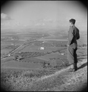 From fortress of Lucera, C Hoskins looks over valley where NZ Division camped, Italy, World War II - Photograph taken by George Kaye