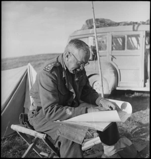 Brigadier G B Parkinson studies his map behind the lines of the Italian battlefront, World War II - Photograph taken by George Kaye