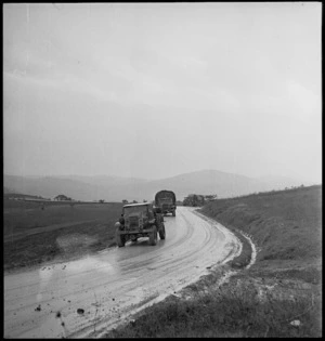 Trucks of the NZ Division making their way over muddy roads to the Italian forward areas, World War II - Photograph taken by George Kaye