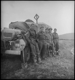 Group of New Zealanders take a break alongside truck as they move up to Italian forward areas, World War II - Photograph taken by George Kaye