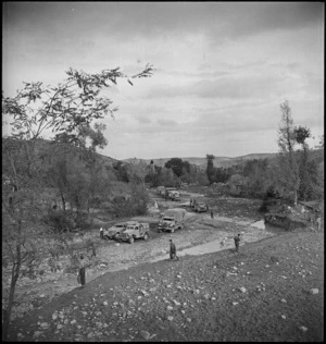 NZE trucks negotiate river bed at the bottom of road leading to Atessa, Italy, World War II - Photograph taken by George Kaye