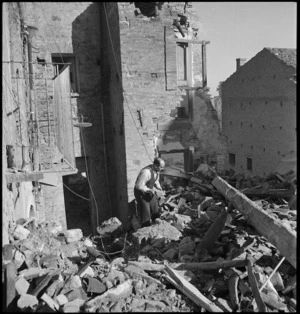 Civilian searches among the ruins of his home in Atessa, Italy, World War II - Photograph taken by George Kaye