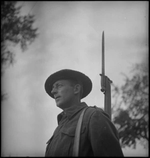 NZ Infantryman A F Sedgwick on guard outside battle HQ in Sangro River area, Italy, World War II - Photograph taken by George Kaye