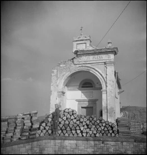Mines piled up in front of a shrine in the town of Atessa, Italy, World War II - Photograph taken by George Kaye
