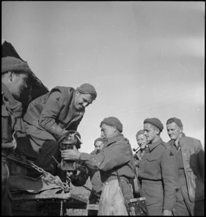 Personnel of a NZ Machine Gun Battalion load truck at the Sangro River front, Italy, World War II - Photograph taken by George Kaye