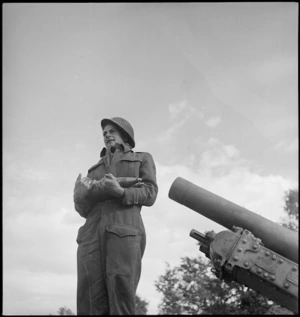 D Young holding artillery shells in a front line gun position, Sangro River area, Italy, World War II - Photograph taken by George Kaye