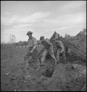 NZ gunners emerge from gunpit on the Sangro River front, Italy, World War II - Photograph taken by George Kaye