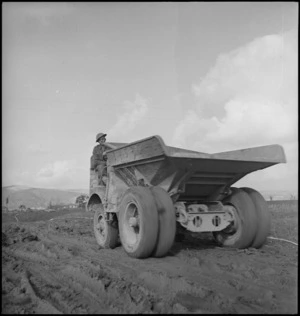 A H Amberger driving a dumptor on road near the Sangro River, Italy, World War II - Photograph taken by George Kaye