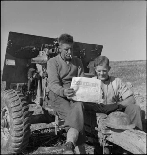 H Drake and R D Morrison reading NZEF Times during lull in fighting on Sangro River Front, World War II - Photograph taken by George Kaye