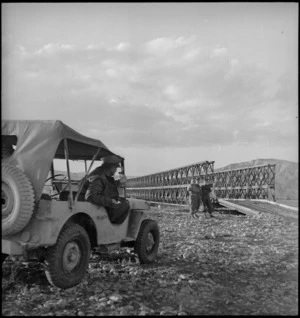 General Freyberg in jeep near Bailey bridge constructed by NZ Engineers across Sangro River, Italy, World War II - Photograph taken by George Kaye