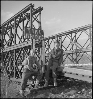 Two New Zealand soldiers on Tiki Bridge across the Sangro River, Italy, World War II - Photograph taken by George Kaye