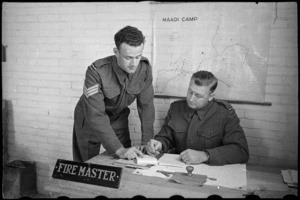 Fire Master WO H S Manning and Sergeant E N Bisset plan daily training of the NZ Maadi Camp Fire Unit, Egypt - Photograph taken by George Bull