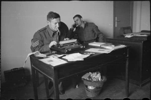 Sergeant D W Lake and Private R W Kirkby of the NZEF Times at work in the Cairo office, Egypt, World War II - Photograph taken by George Bull