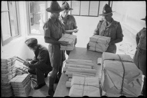 Wrapped bundles of the NZEF Times handed over to the NZ CPO for delivery, Egypt, World War II - Photograph taken by George Bull