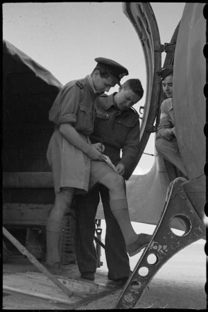Pilot Officer J R Ford signs for consignment of the NZEF Times for transport to Italy, World War II - Photograph taken by George Bull