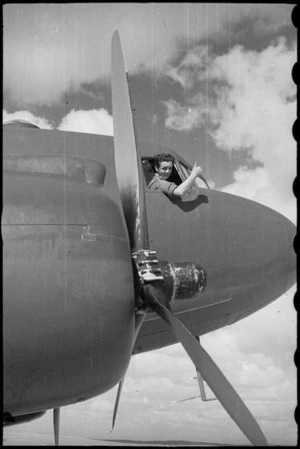 Pilot Officer J P Ford gives the OK before taking off with a load of NZEF Times for the NZ Division in Italy, World War II - Photograph taken by George Bull