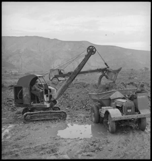 NZ Engineers using a mechanical shovel and dumptor in the forward areas of the Italian Front, World War II - Photograph taken by George Kaye