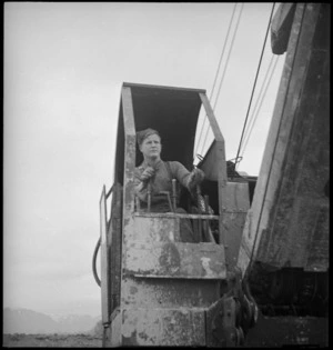 F T Gill operating a mechanical shovel in the forward areas of the Italian Front, World War II - Photograph taken by George Kaye