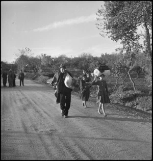 Refugees forced to leave their homes trudge along country roads in the Sangro River areas, Italy, World War II - Photograph taken by George Kaye