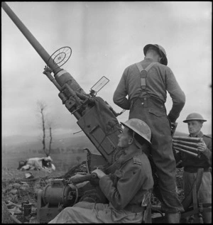 F A Thompson at action station on a NZ anti aircraft gun in Italy, World War II - Photograph taken by George Kaye