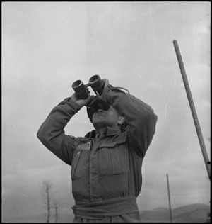 A J Rzoska on the alert for enemy planes on a NZ anti aircraft gun post on the Italian Front, World War II - Photograph taken by George Kaye