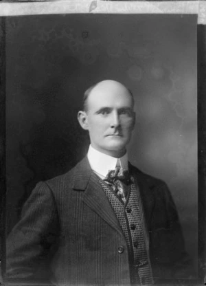 Studio upper torso portrait of an unidentified man, in a striped suit and patterned waistcoat, double round shirt collar and silk cravat tie,location unkwnown.