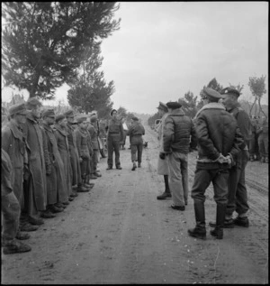 General Sir Alan Brooke passes down line of German prisoners during visit to NZ Division in Italy, World War II - Photograph taken by George Kaye