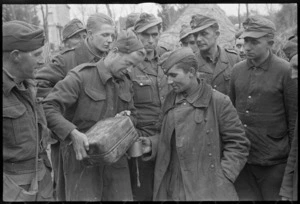 New Zealand soldier, Alf Richardson, pours water for German prisoners taken on the Italian Front, World War II - Photograph taken by George Kaye