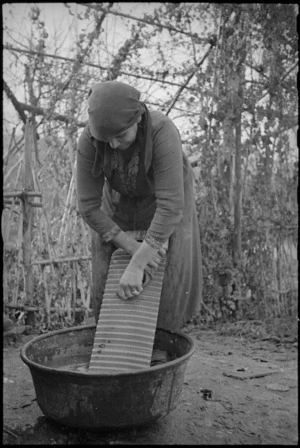 Italian woman doing washing as life returns to normal after 8th Army advances in World War II - Photograph taken by George Kaye