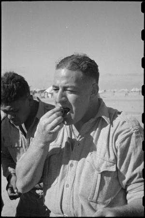 D McClutchie tries out hangi-cooked potatoes at the Maori Training Depot, Christmas Day, Egypt - Photograph taken by George Robert Bull
