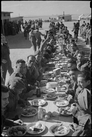 Looking along one of the tables laden with Christmas Dinner at the Maori Training Depot, Egypt - Photograph taken by George Robert Bull