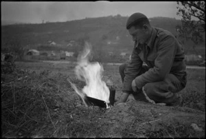 M Lyttle boils the billy in the forward area of the Italian Front, World War II - Photograph taken by George Kaye
