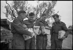 RAF personnel attached to NZ Division on the Italian Front receive Patriotic Fund parcels a few days before Christmas, World War II - Photograph taken by George Kaye