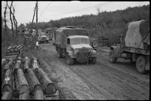Vehicles of 2 NZ Division moving along muddy roads in forward areas of the Italian Front, World War II - Photograph taken by George Kaye