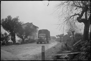 Trucks of 2 NZ Division advancing over muddy roads in the forward areas of the Italian Front, World War II - Photograph taken by George Kaye