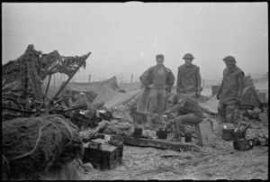 A hot brew being prepared under difficult conditions by some men of the 2 NZ Divisional Artillery, Italian Front, World War II - Photograph taken by George Kaye