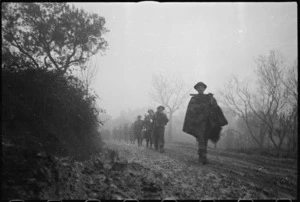 NZ Infantry formation making its way through mist and mud to the Italian Front Line on Christmas Eve, World War II - Photograph taken by George Kaye