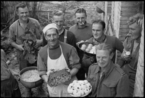 Members of Public Relations Service, Field Section, lend a hand with Christmas dinner in Italy, World War II - Photograph taken by George Kaye