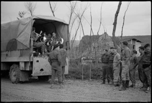 Members of 4 Armoured Brigade band play carols on Christmas morning near NZ Division HQ, Italy, World War II - Photograph taken by George Kaye