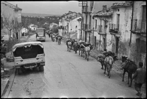 Long procession of mules moving through Castelfrentano, Italy, World War II - Photograph taken by George Kaye