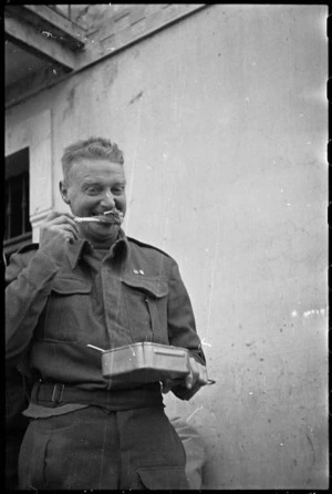 Andy Crawford, NZPRS, eating Christmas dinner in Italy, World War II - Photograph taken by George Kaye
