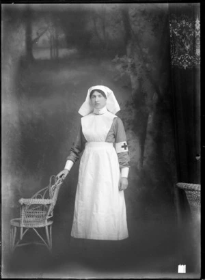 Studio portrait of unidentified female nurse, in a Red Cross uniform, probably Christchurch district