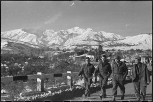 NZ soldiers on road on north side of Sangro River with snow-clad Mount Amaro in the background, Italy, World War II - Photograph taken by George Kaye