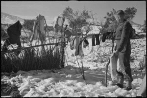 S H Foote hangs out clothes to dry in the New Zealand Sector of the Italian Front, World War II - Photograph taken by George Kaye