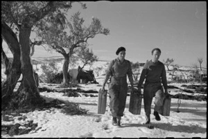 C W J Thomas and W W Buchanan carrying petrol to their trucks in the NZ Sector of the Italian Front, World War II - Photograph taken by George Kaye